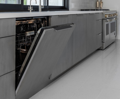 A kitchen with a JennAir Panel-Ready Dishwasher with the door opened and a JennAir Double Oven below a JennAir Cooktop.  